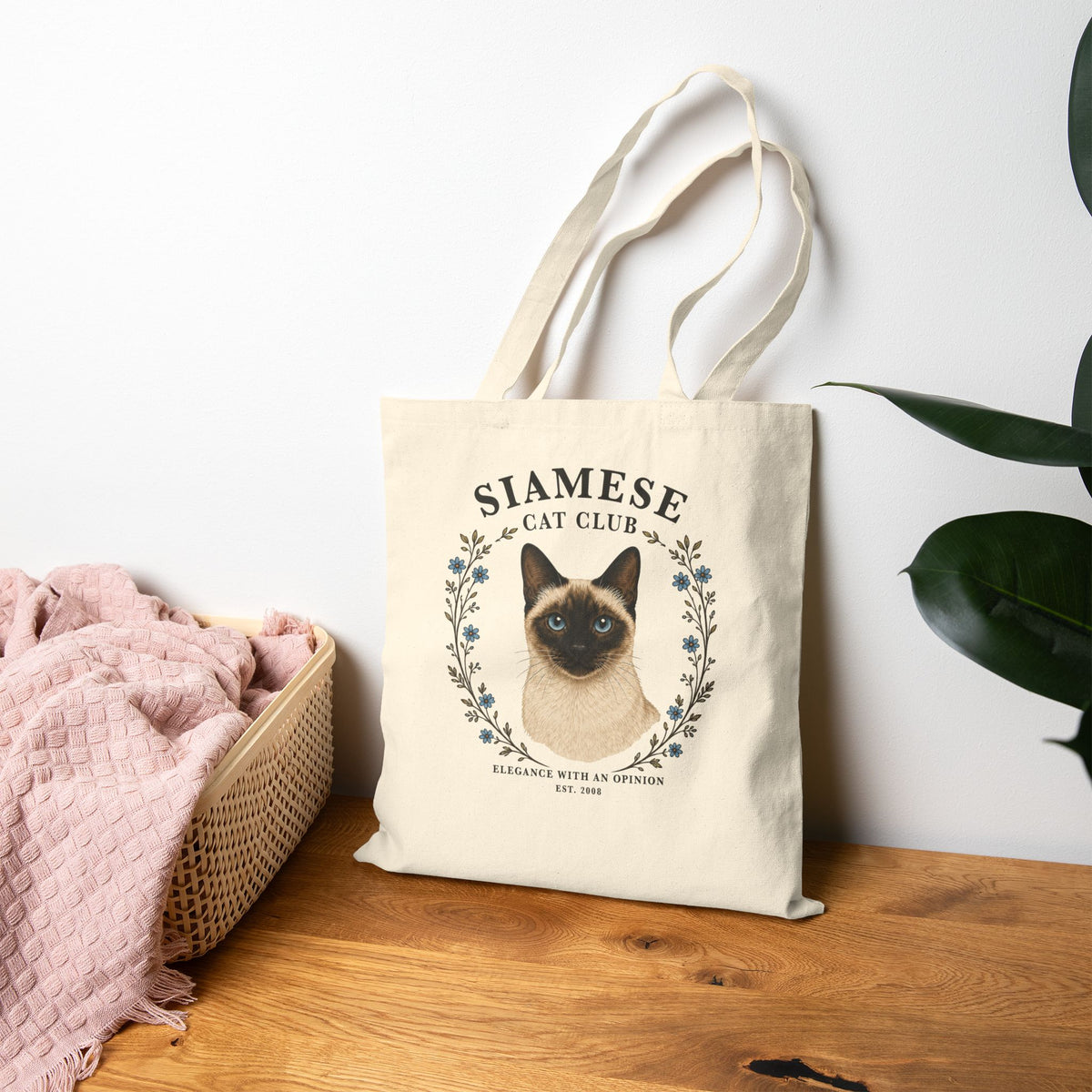 Siamese tote bag with floral decor leaning on the wall.